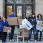 Members of the Magellan Promotions team delivering donations.
